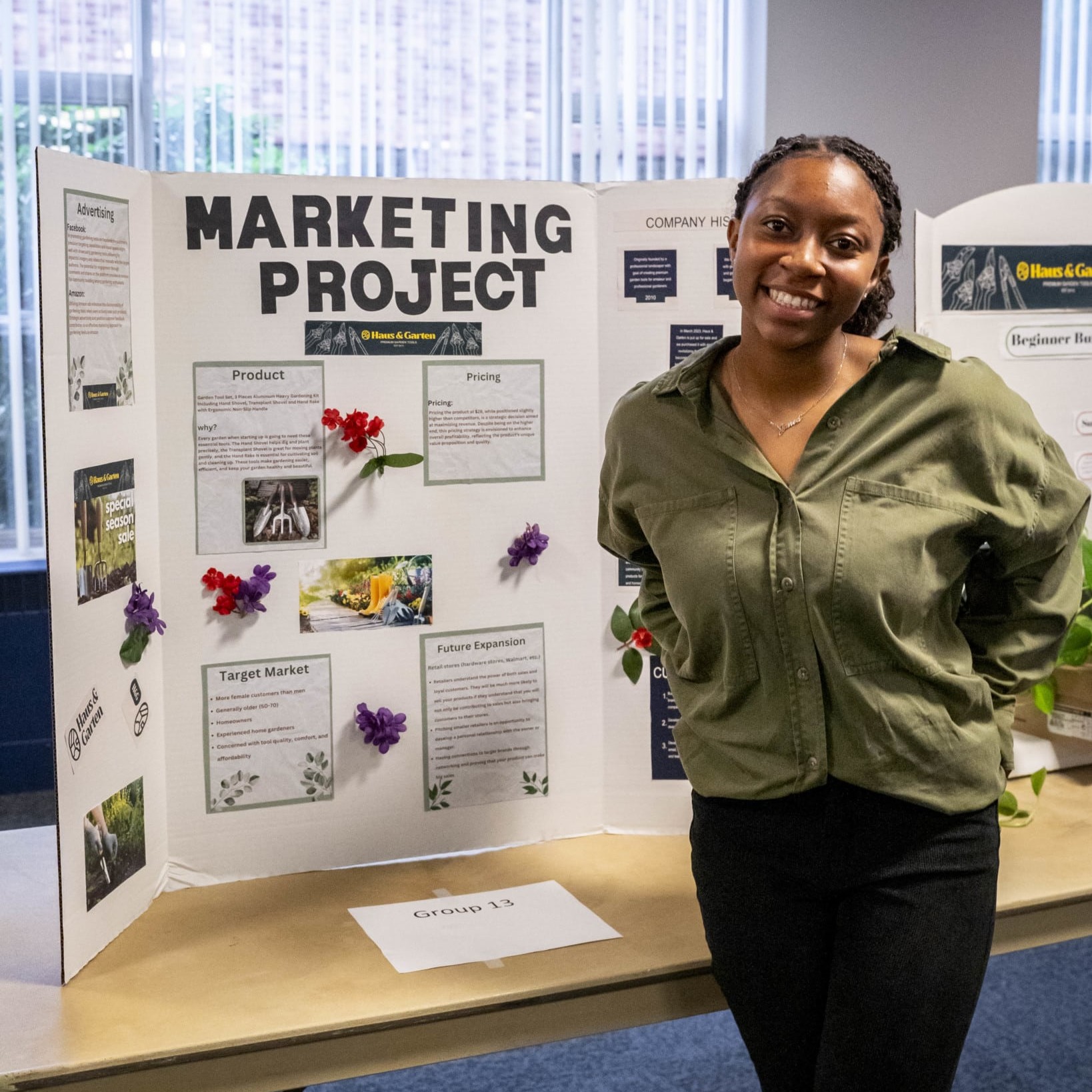 student posing in front of a posterboard