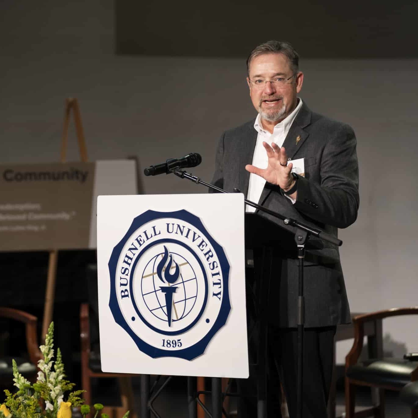 President Womack talking in front at a podium