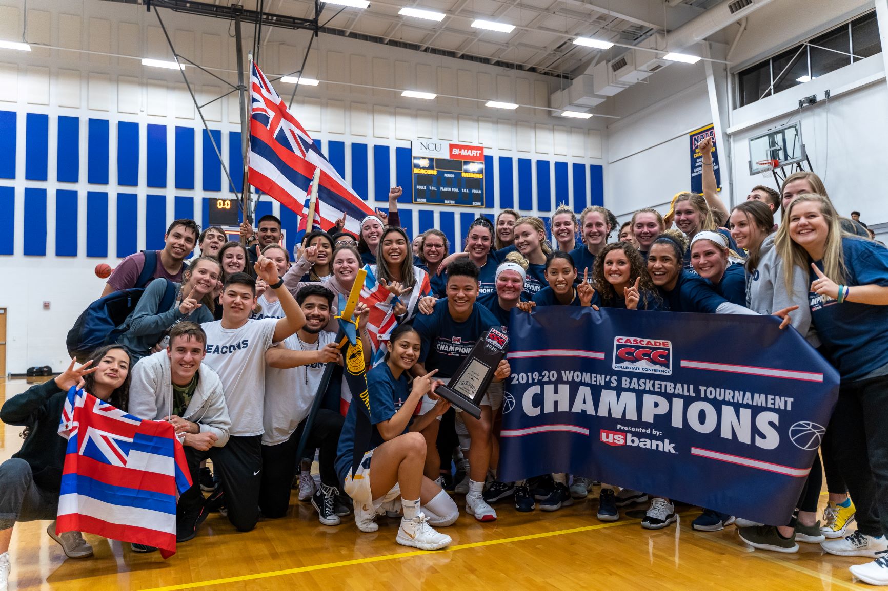 people holding a championship banner