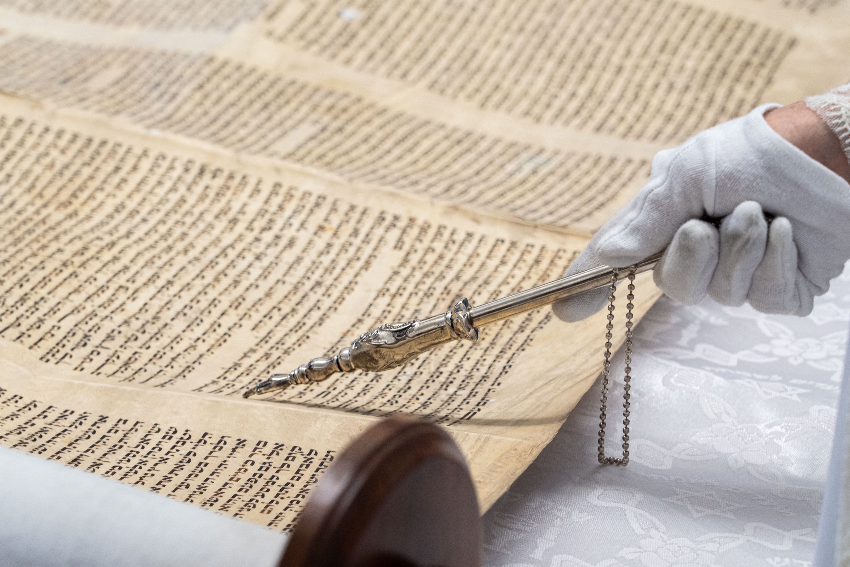 Close-up of a historical scroll being examined with a pointer during a hands-on learning experience at Bushnell University.