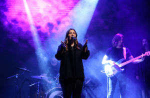 Student musicians performing contemporary music on stage during a live concert.
