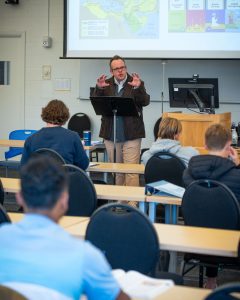 Professor engages students in classroom discussion during a lecture at Bushnell University.