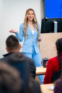 Student presenter leads a classroom discussion at Bushnell University as classmates listen and engage on ACE Day.