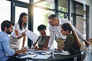 Business professionals collaborate during a team planning meeting.