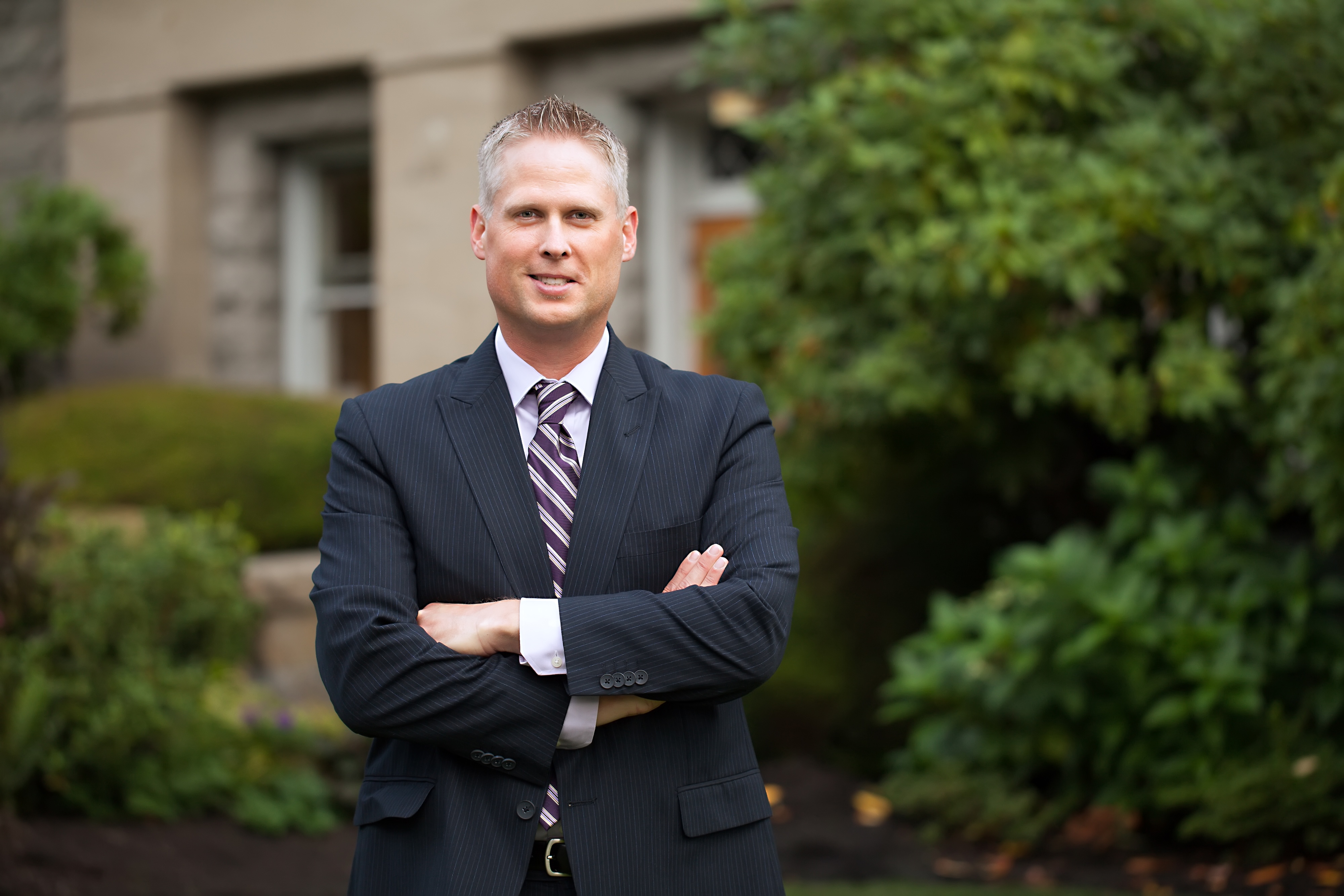 Business student standing outside on the Bushnell University campus.