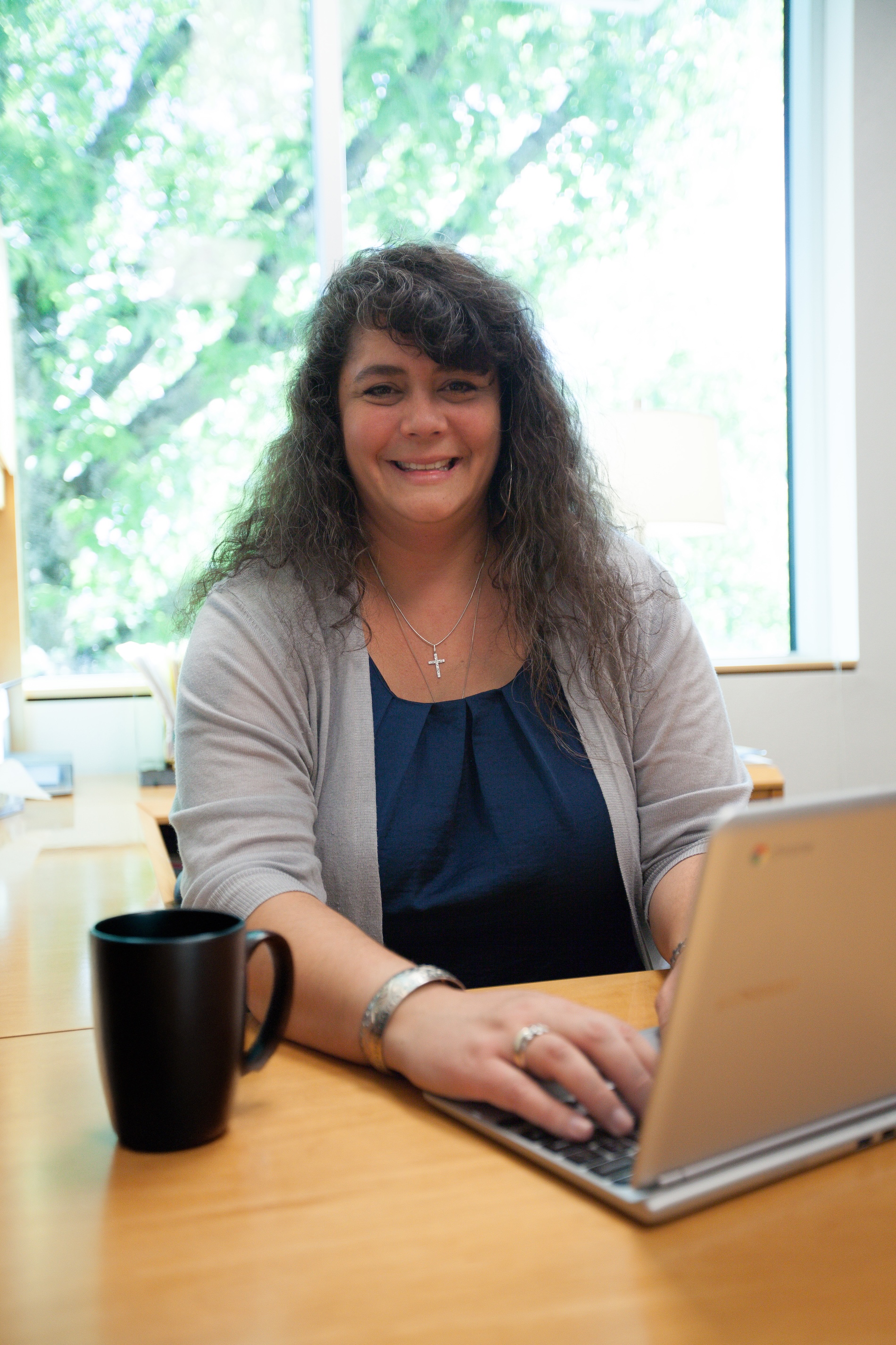 Graduate student using a laptop while studying at Bushnell University.