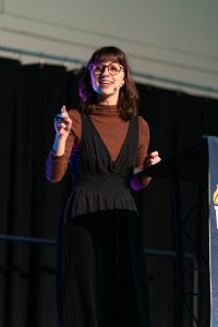 Bushnell University student speaks at the podium during a campus chapel service.