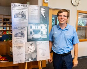 History major showcasing historical publications during a research presentation
