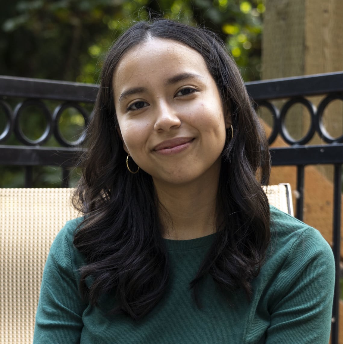 Bushnell University student smiling for an outdoor portrait.