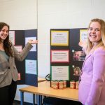 Business administration students presenting research projects in a classroom setting