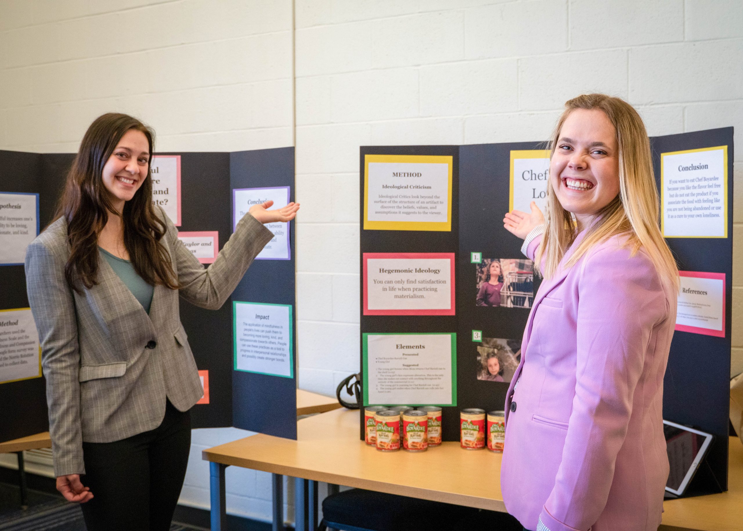 Business administration students presenting research projects in a classroom setting
