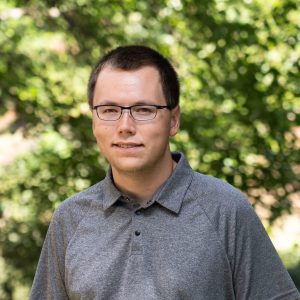 Male honors student with grey shirt headshot outdoors
