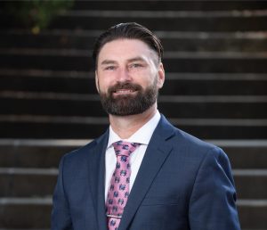 Business and law professional in a blue suit and pink tie