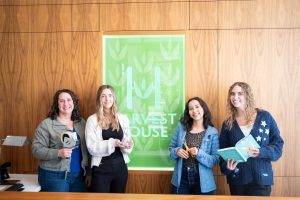 Group photo of students at a publishing house internship with the organization's sign
