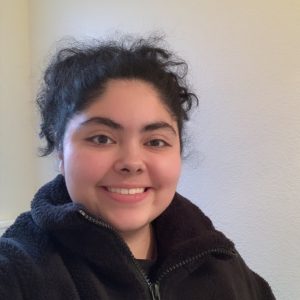 headshot of a female psychology student in a black sweater