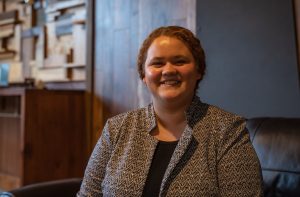 Female student headshot with a rustic background