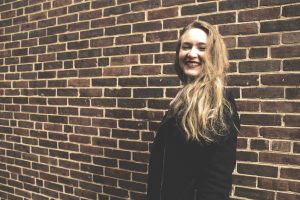 Headshot of a female student against a brick background