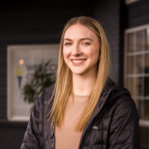 Headshot of a young woman student with blonde hair and jacket