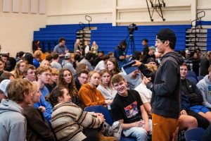 Students listening to classmate while preaching during chapel