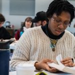 Bible and Theology student reads their bible during a class retreat