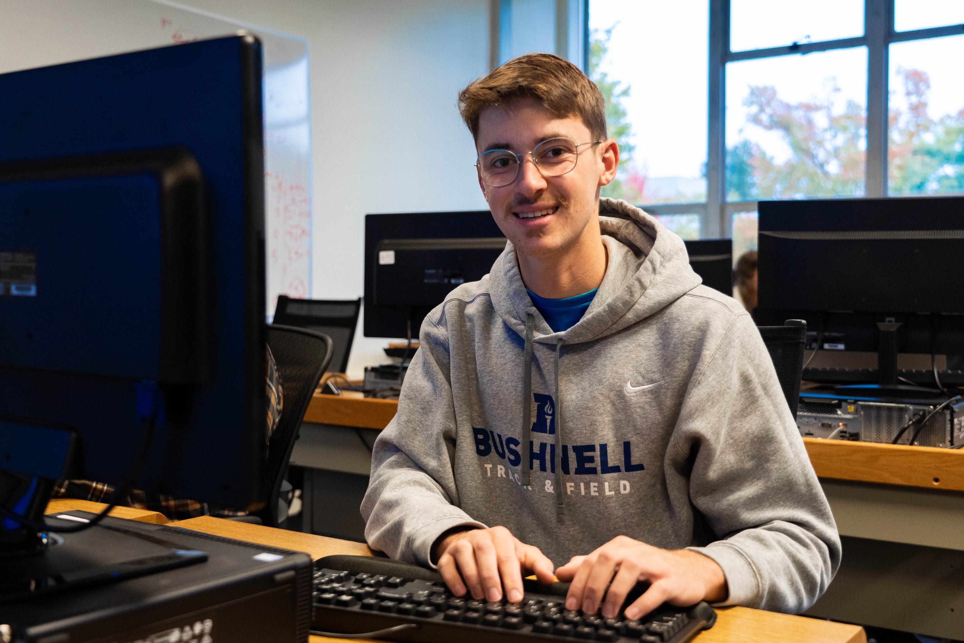 Student working at a desktop computer in a Bushnell University computer lab.