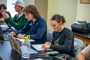 Students in a lab classroom studying on their laptops