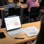 A psych student's tablet and worksheet displaying a diagram of brain anatomy