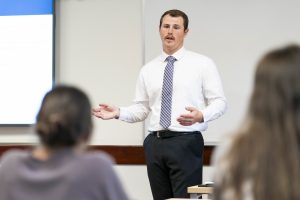 Bushnell University student delivers a professional presentation to classmates.