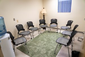 Small group discussion room with chairs arranged in a circle for nursing simulations, debriefing sessions, and collaborative learning.