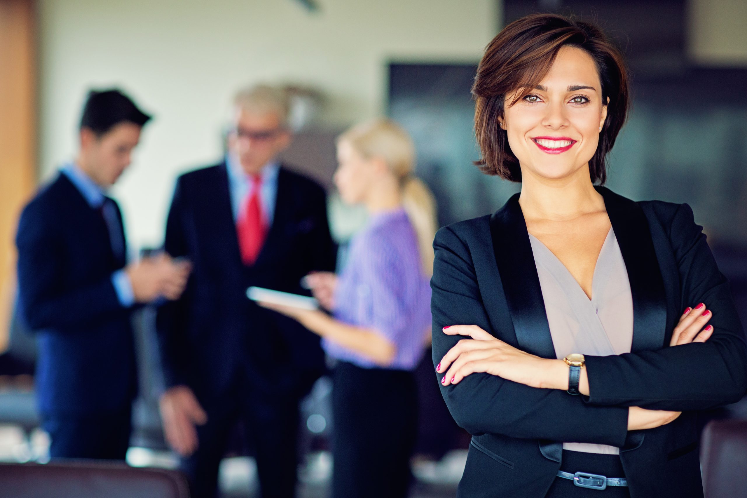 Business professional standing in an office environment representing leadership and career advancement.