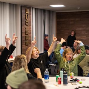 Attendees cheer and participate in a family weekend event.