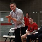 Bushnell University's newly hired wrestling coach directs athletes during a collegiate wrestling competition prior to joining Bushnell.