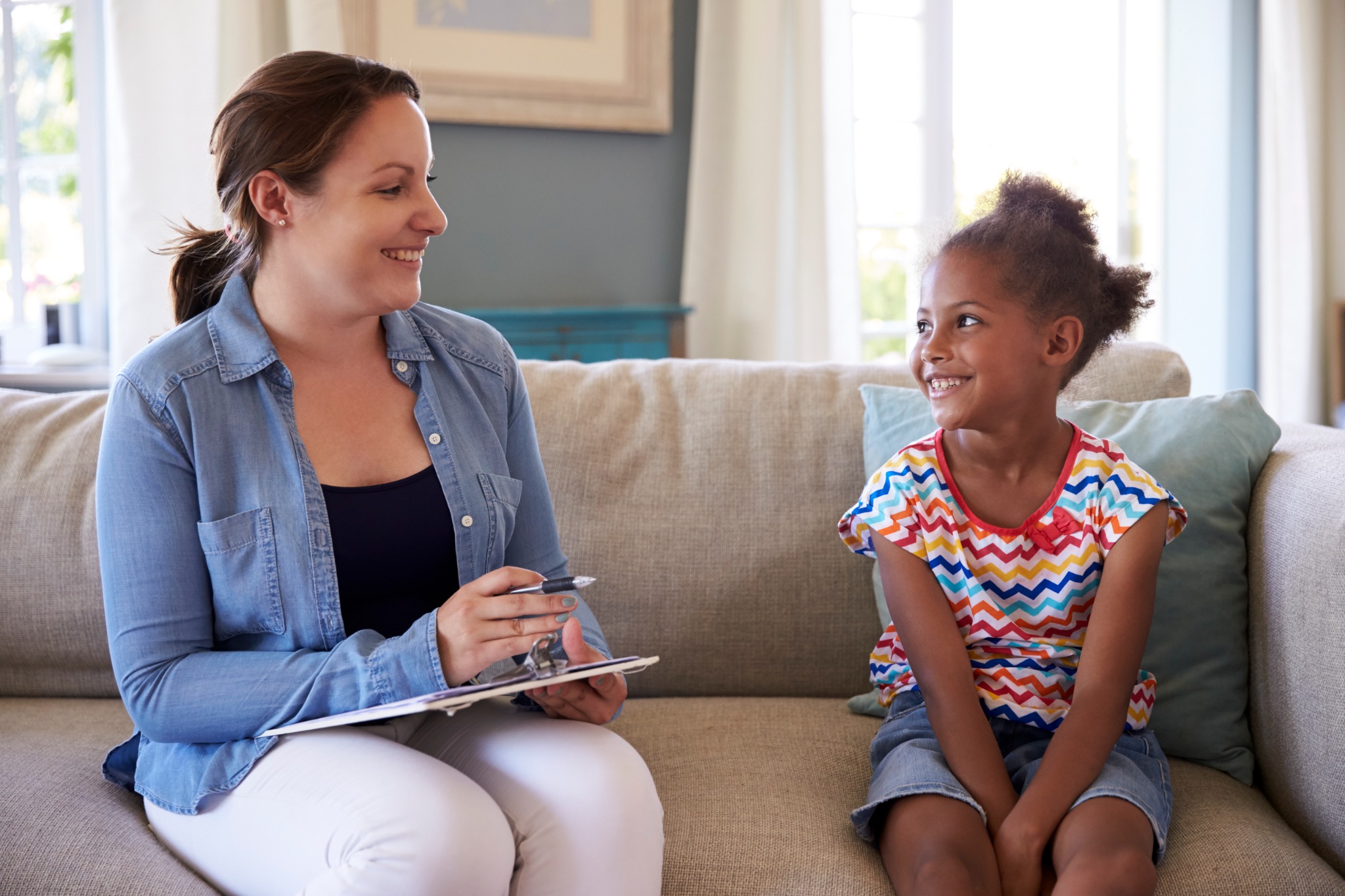 School counselor meeting one-on-one with an elementary student in a supportive counseling session.