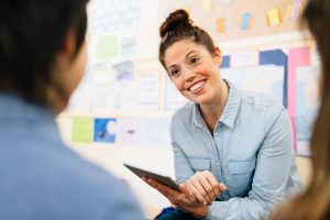 School counselor meeting with students in an elementary classroom.