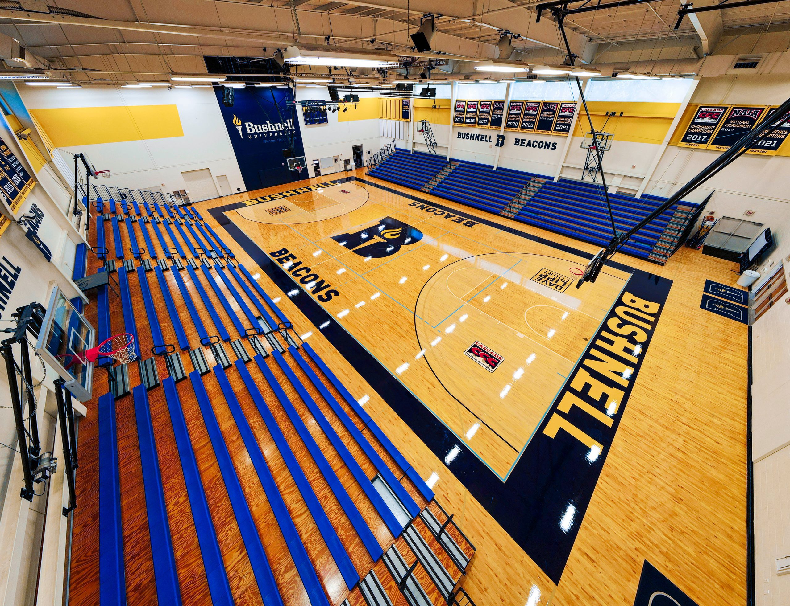 Overhead photo showing off the Bushnell basketball court in the Morse Center with wood polished floors and athletic logo in the center.