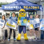 Bushnell University student ambassadors and the Beacon mascot welcome new students during New Student Orientation.