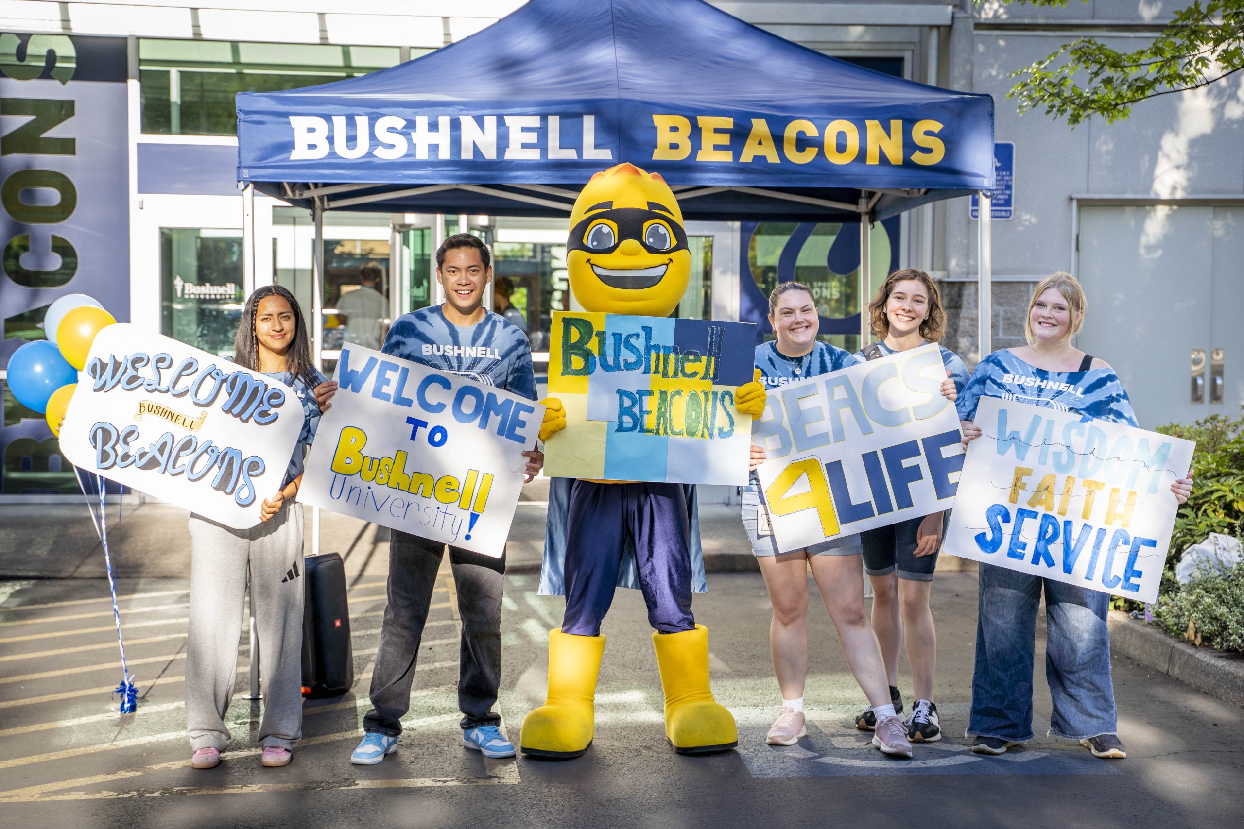 Bushnell University student ambassadors and the Beacon mascot welcome new students during New Student Orientation.
