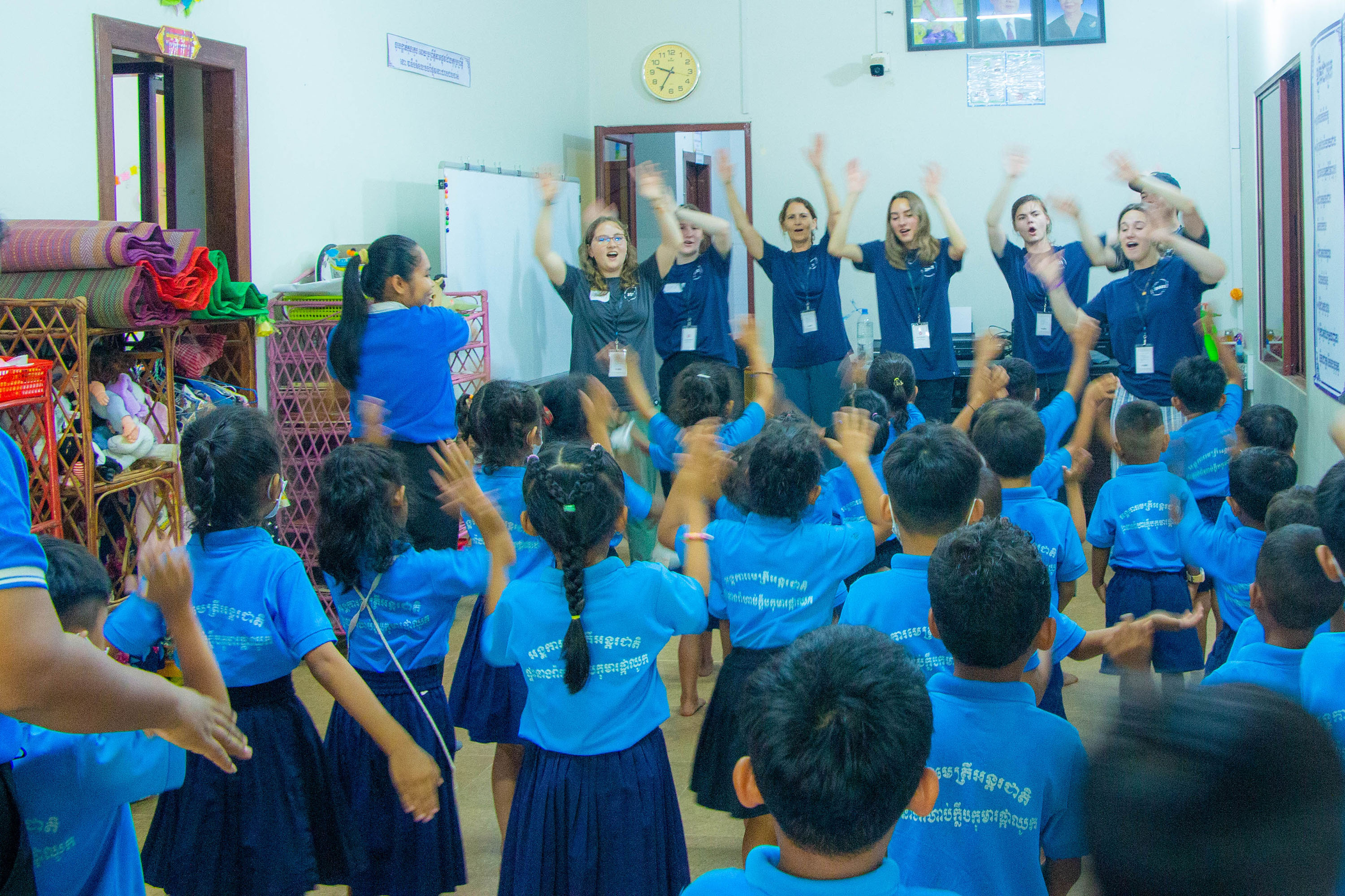 Cambodia mission team dances and perform songs for children at a school.