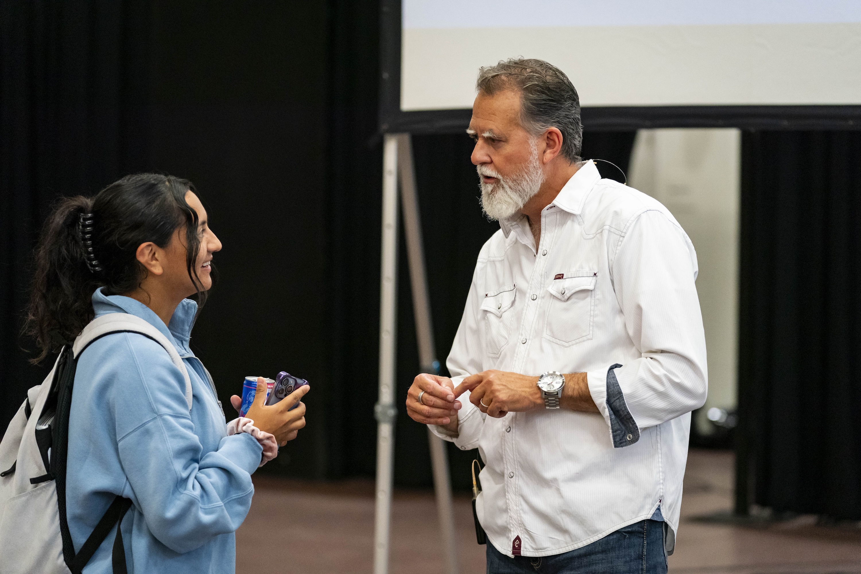 Chapel speaker talks with a Bushnell University student following a campus chapel service for a becoming beloved community event.