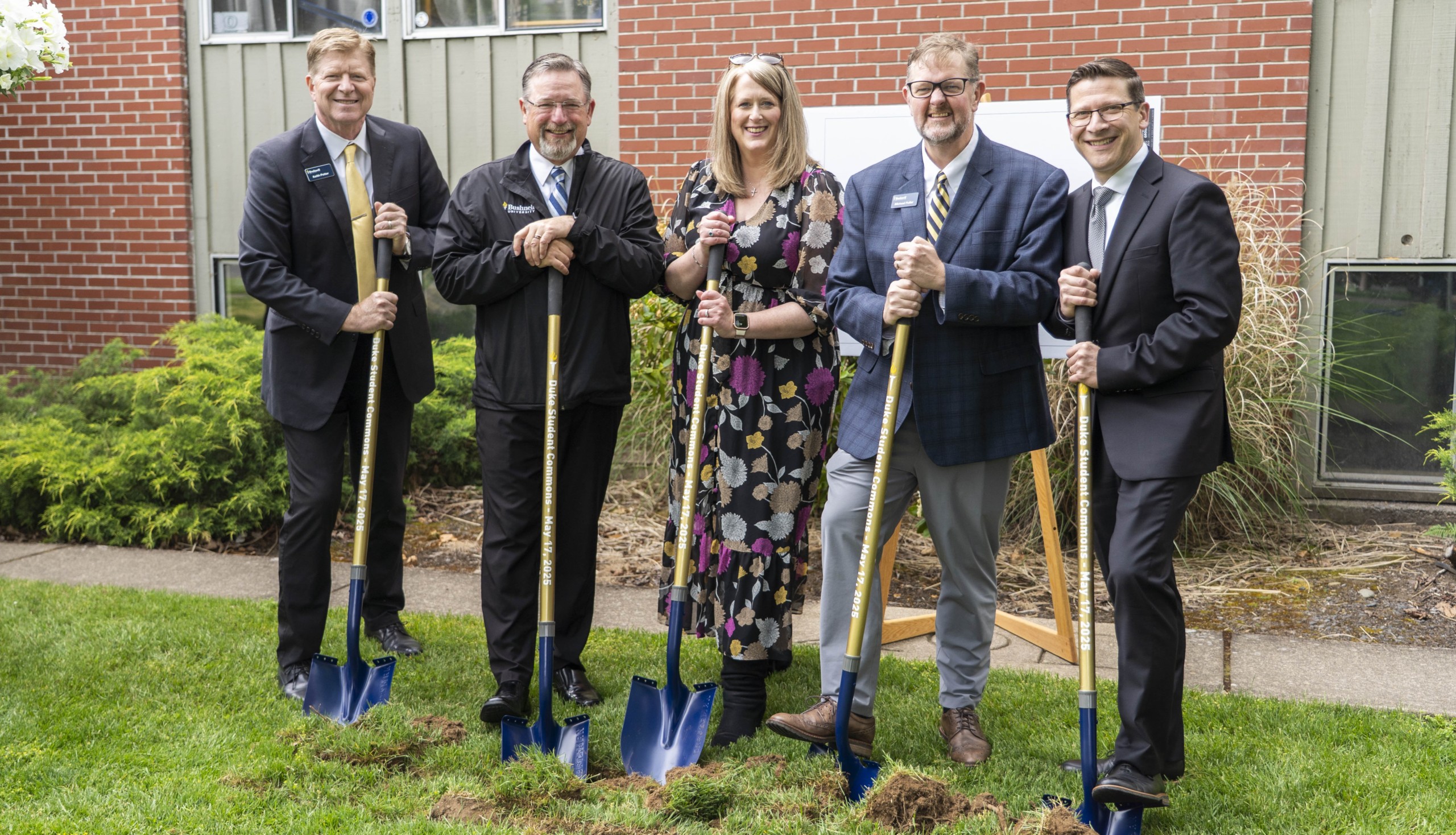 Bushnell University leaders pose with ceremonial shovels during the groundbreaking for Duke Commons.