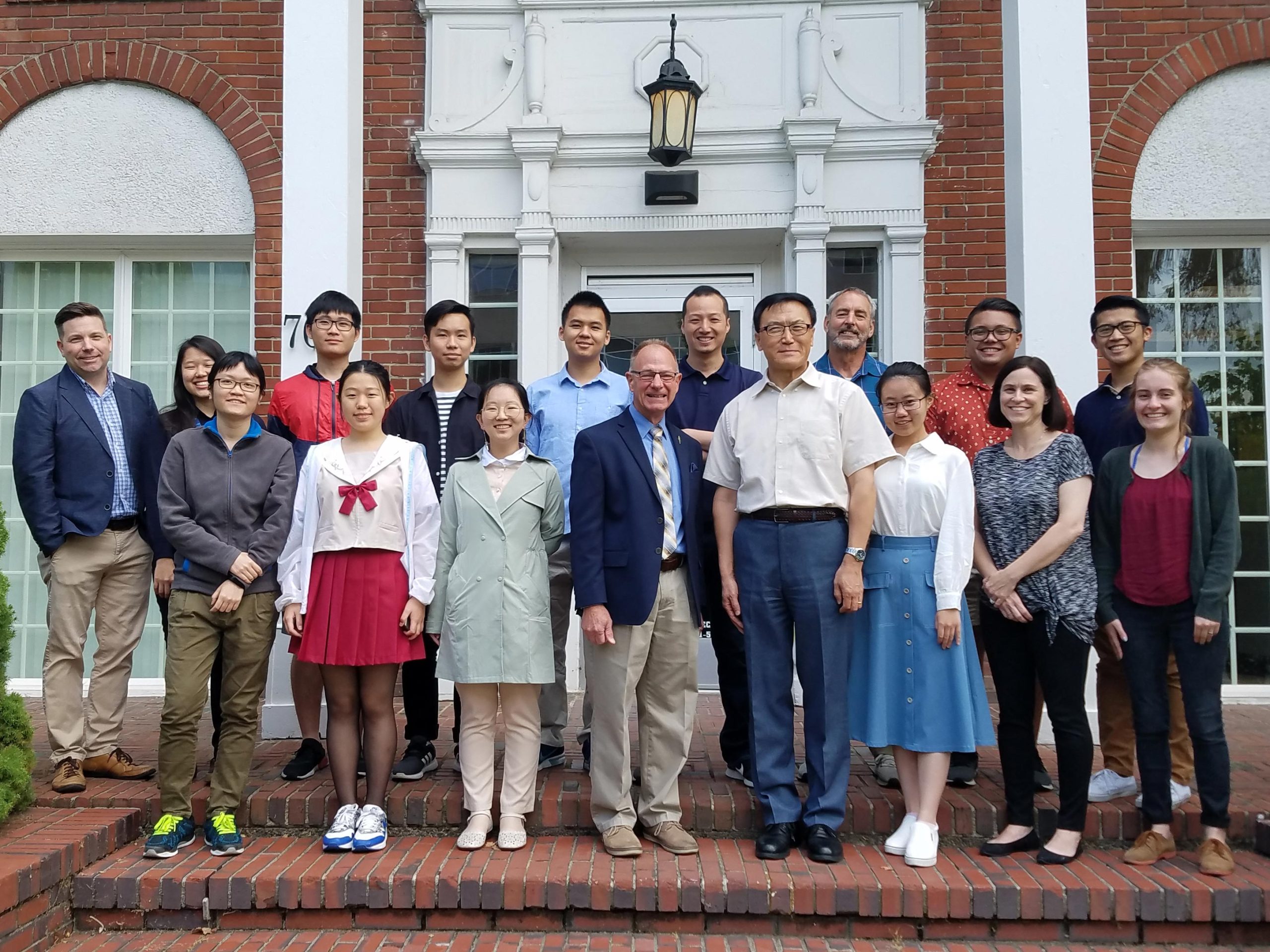 International students, faculty, and campus guests gather for a group photo at Bushnell University.