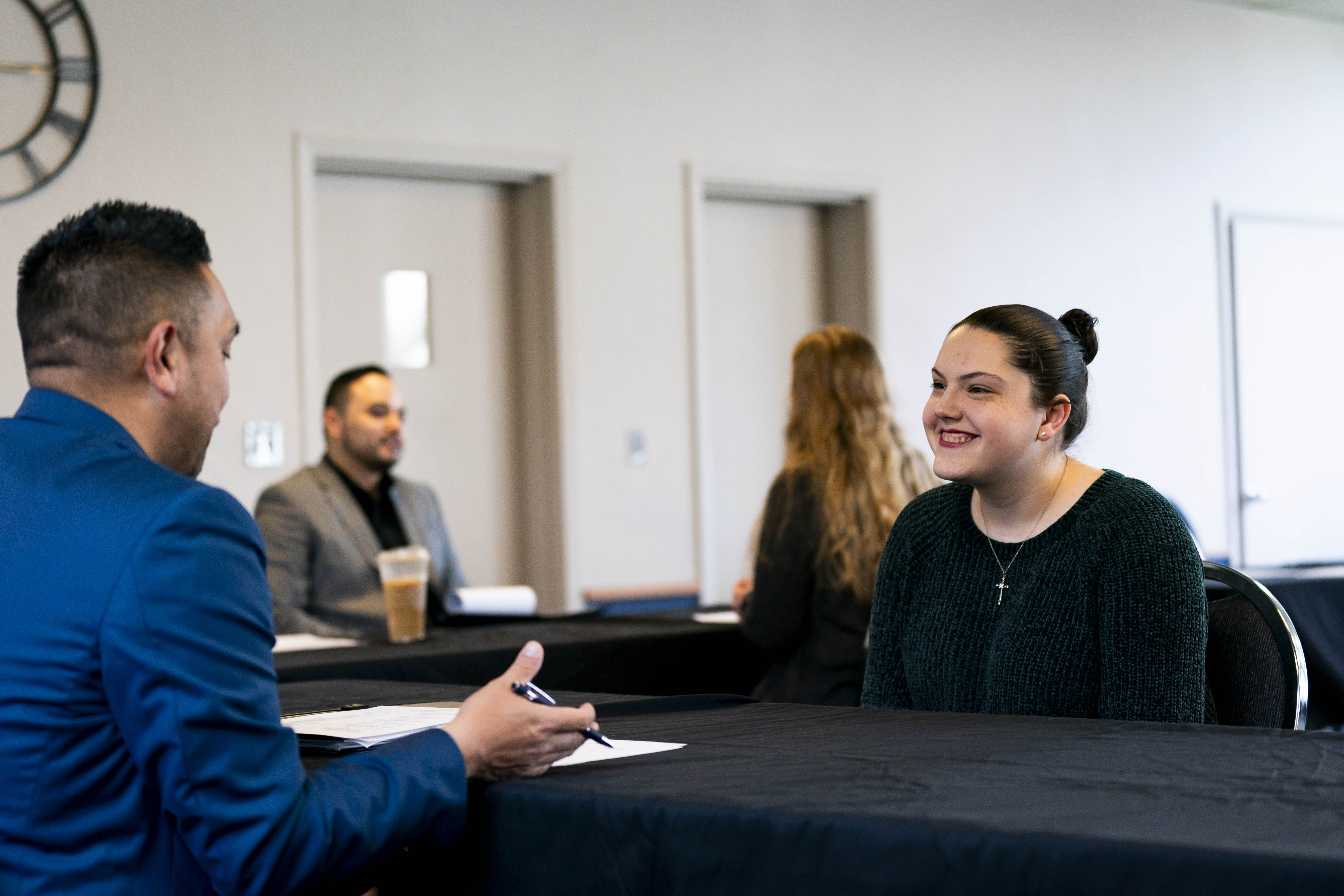 Bushnell University student participates in a mock job interview with a professional during a career development event.