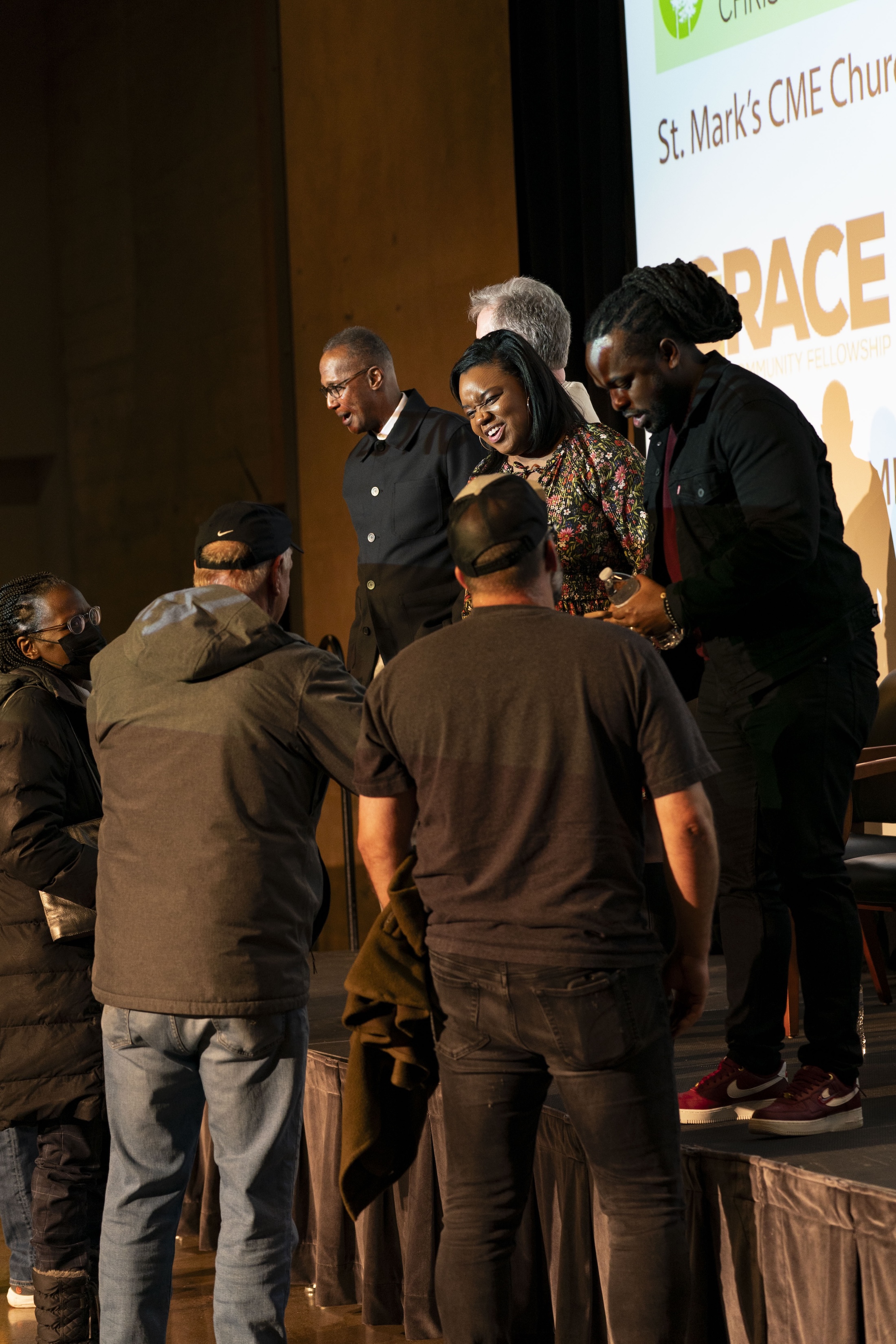 peakers greet attendees following a Bushnell University becoming beloved community event.