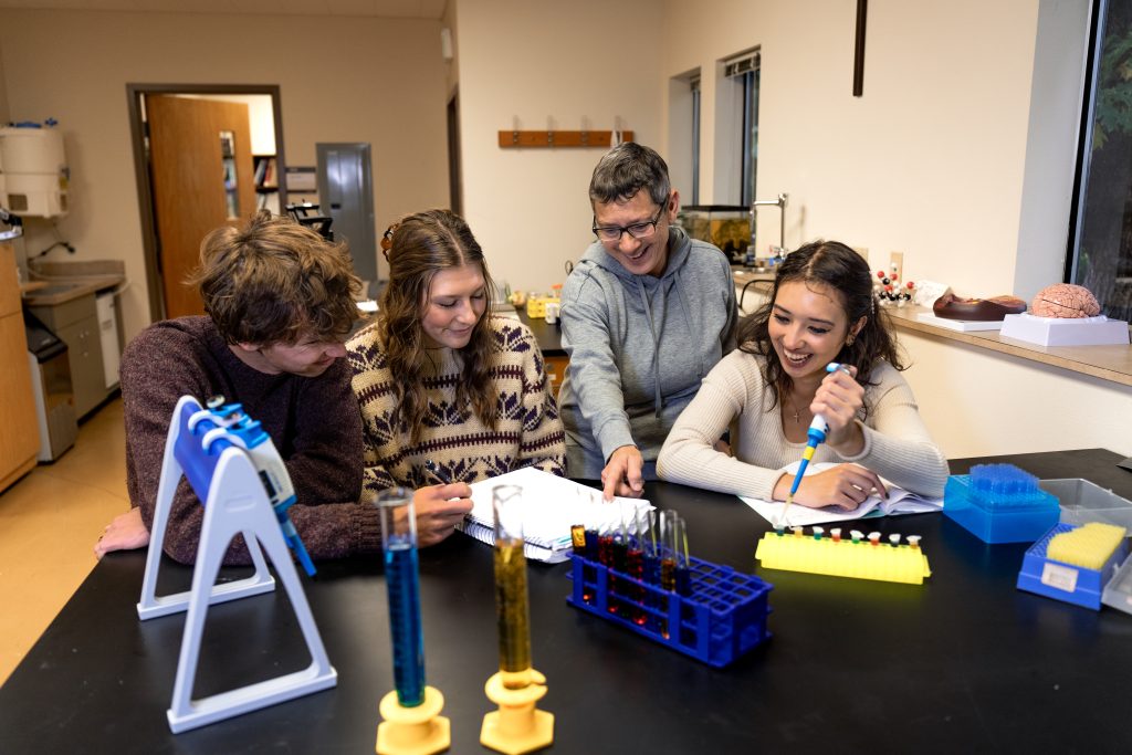 Bushnell University professor works with students during a hands-on laboratory class.