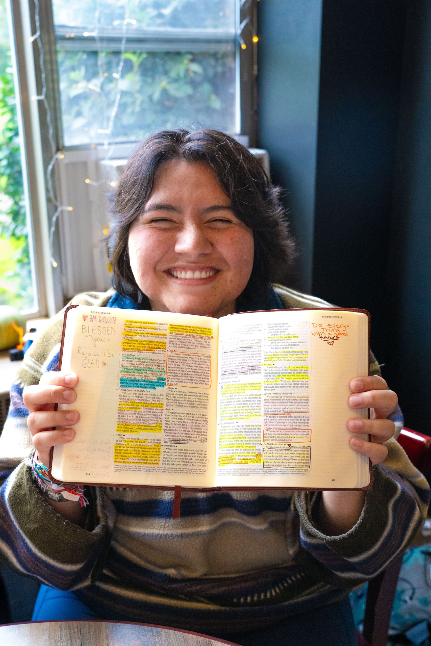 A student shows their personal Bible filled with highlighted scripture and notes.