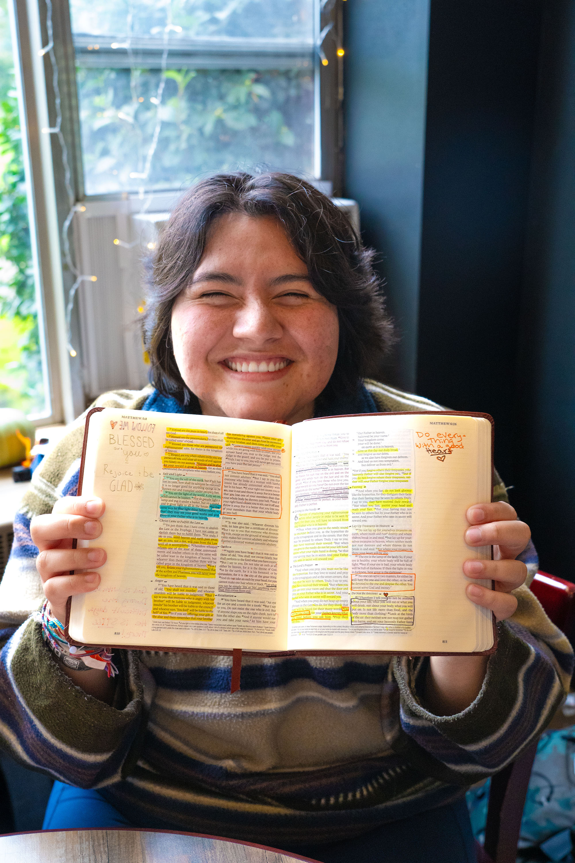 A student shows their personal Bible filled with highlighted scripture and notes.