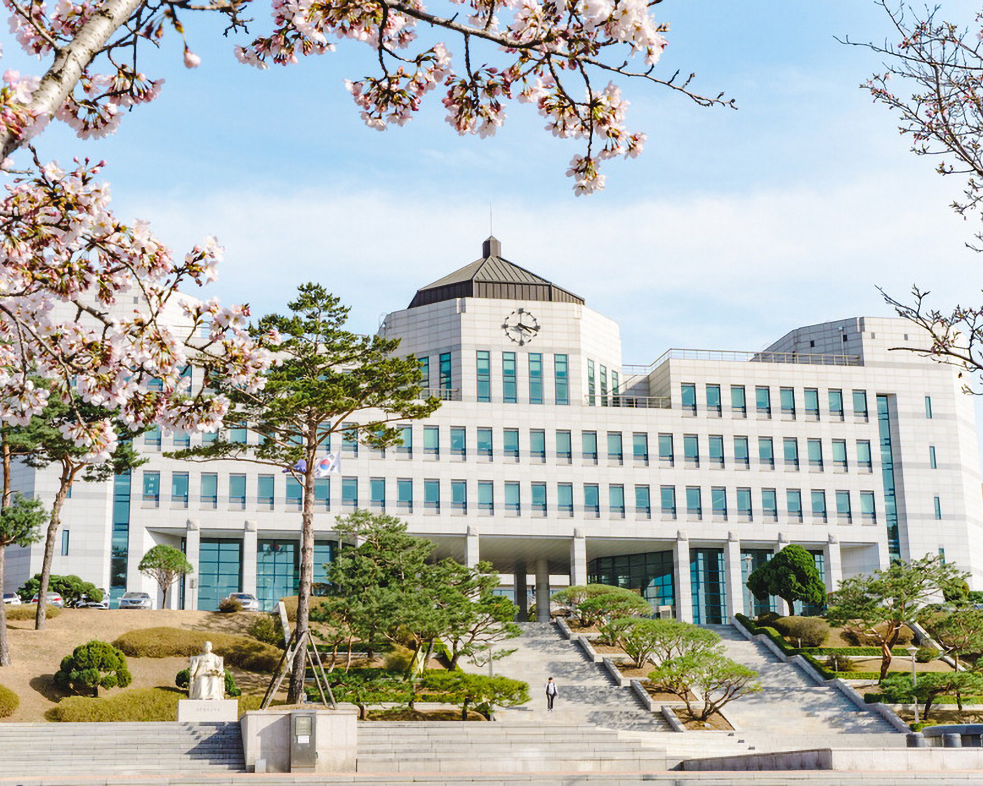 Dankook University main building of white stone with flights of stairs leading up to it.