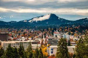 View of downtown Eugene, Oregon, with Skinner Butte and fall foliage in the background.