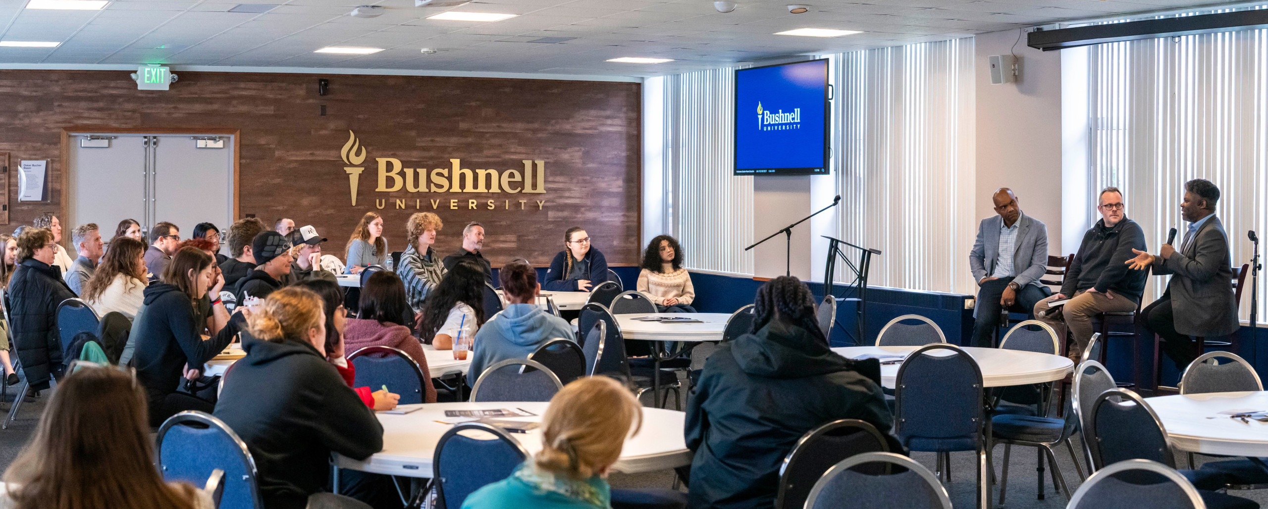 Students attend a panel discussion hosted at Bushnell University.