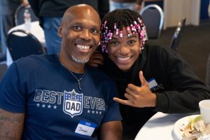 A new Bushnell University student smiles with a family member during a Family Weekend event.